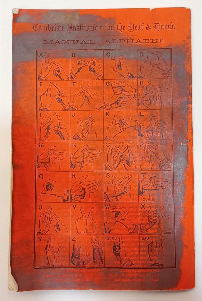 The rear cover of the Cambrian Institution of the Deaf and Dumb Annual report 1868-9 showing a visual of the manual alphabet