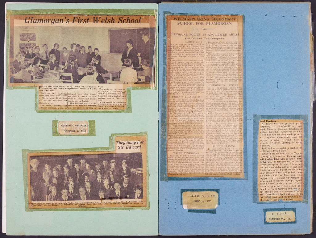 A scrapbook page featuring articles and photographs related to Glamorgan's first Welsh school, including a group photo of students and a teacher, along with newspaper clippings discussing bilingual education.